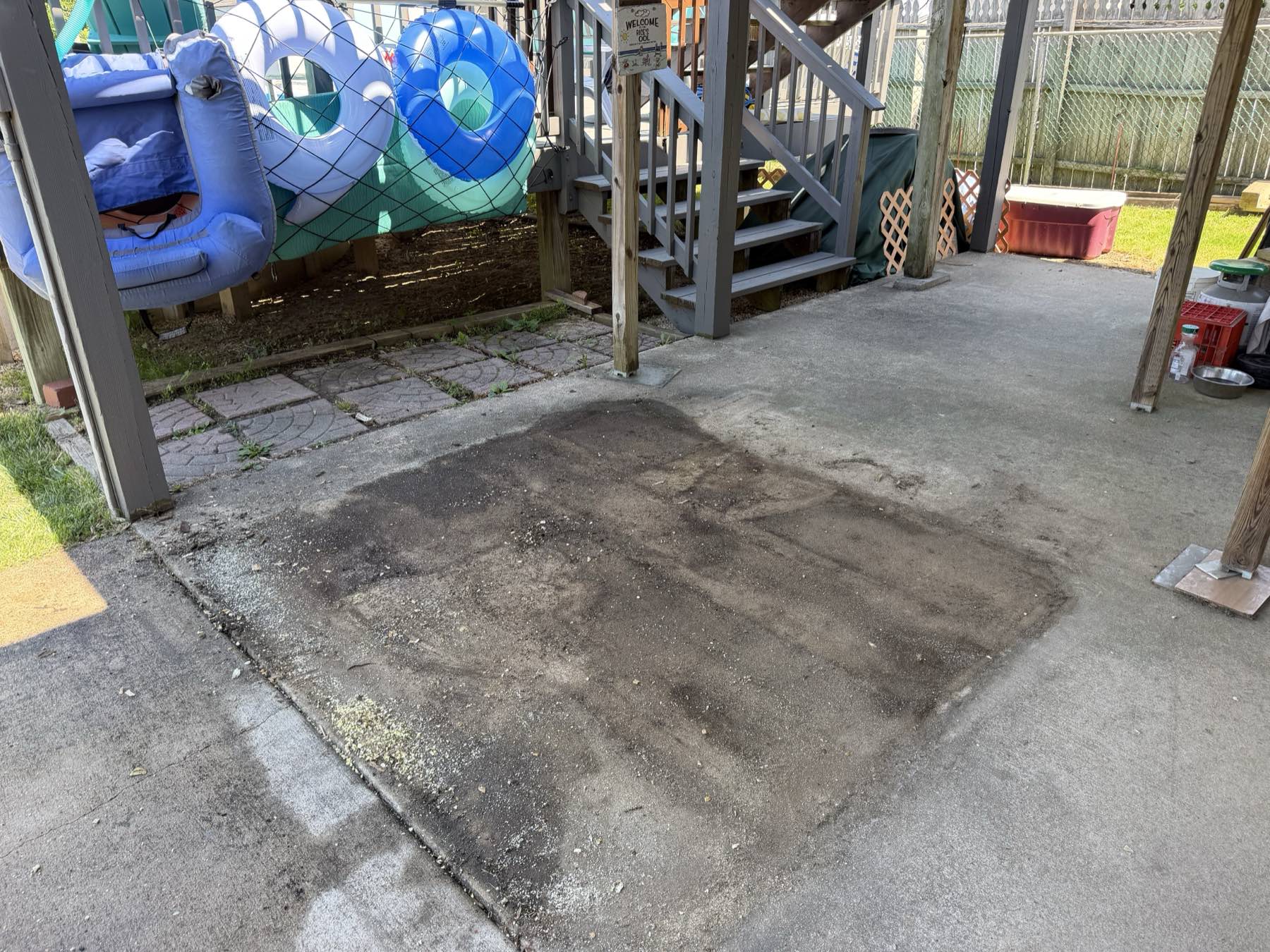 The same patio with the hot tub gone, only a faint outline left on the concrete