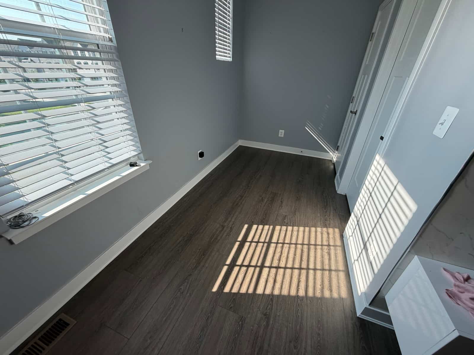 The same bedroom emptied out, bare floor, ready to go