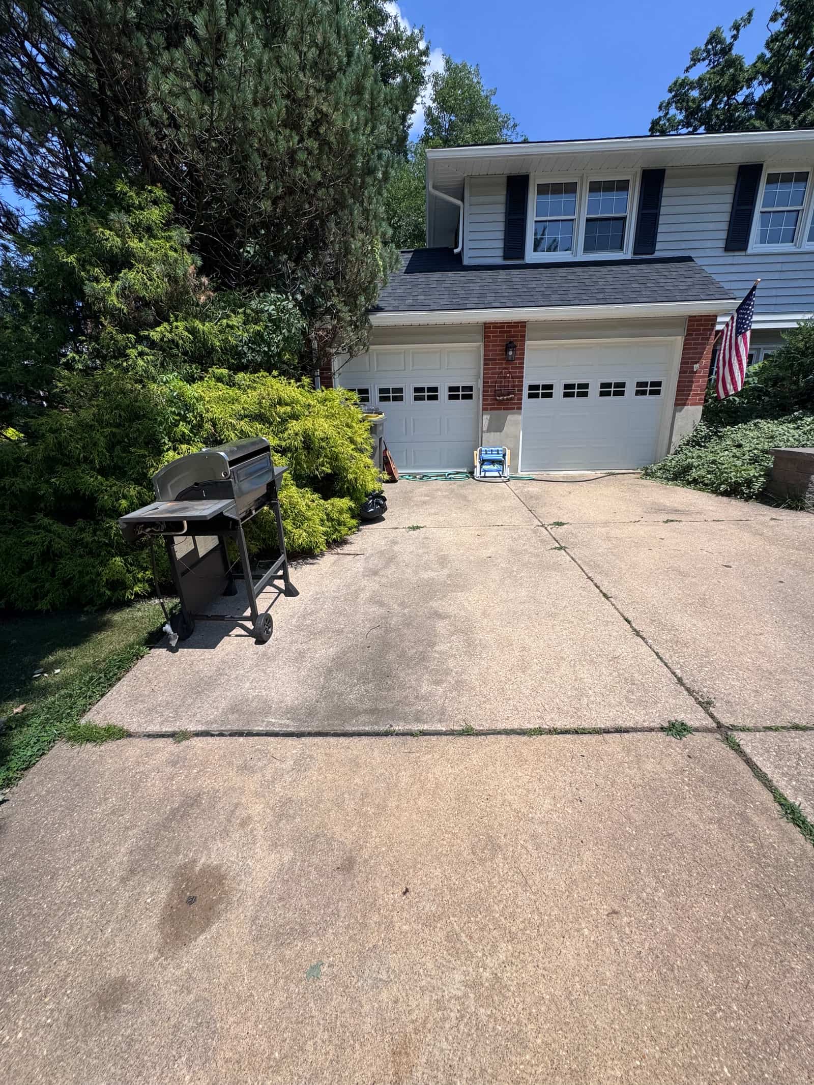 The same driveway cleared of everything except a grill, swept clean