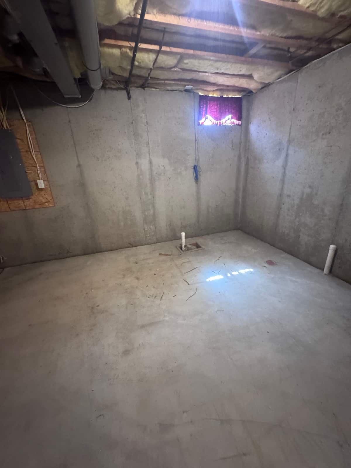 The same Middletown basement corner emptied down to the bare concrete floor
