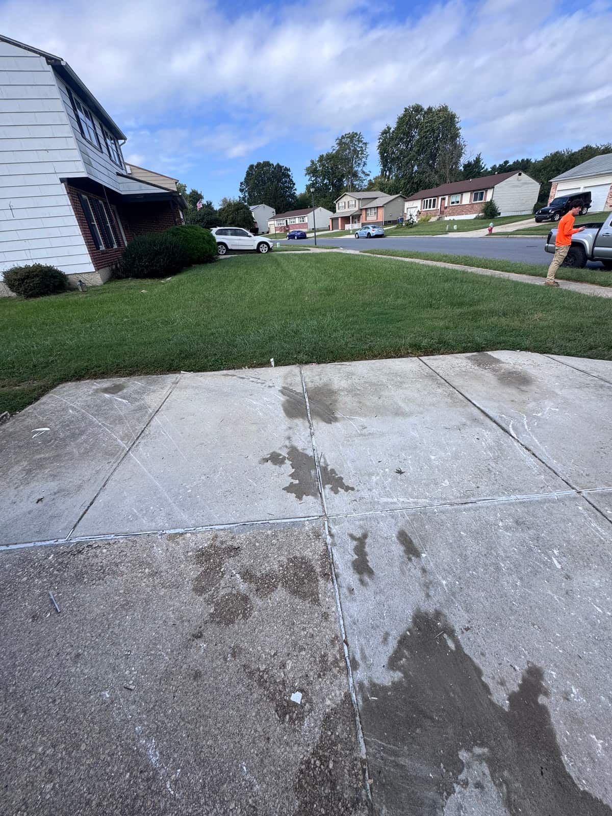 The same Dover driveway cleared, with only a few wet marks on the concrete where the bags sat