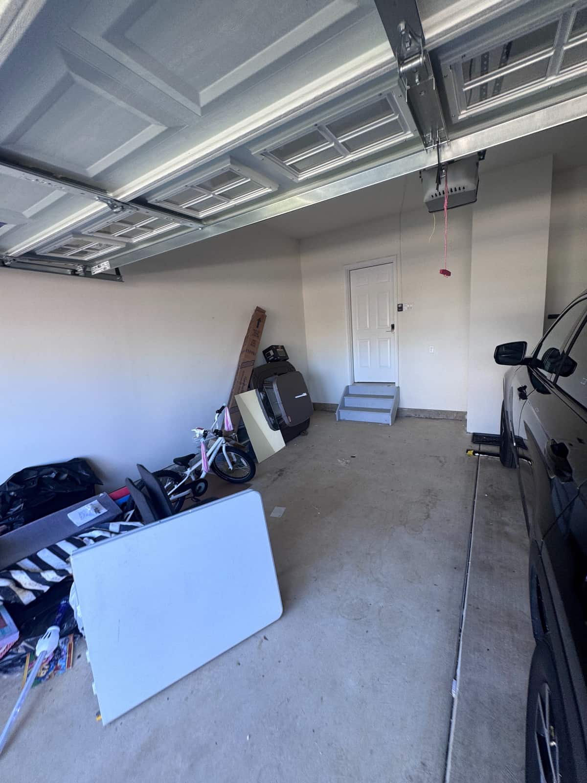 The same Middletown garage with the floor cleared and the car parked back inside