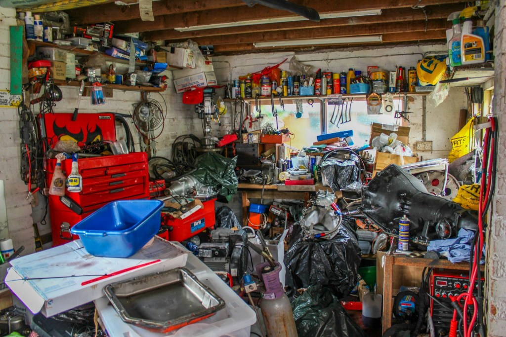 a garage filled with lots of clutter and tools