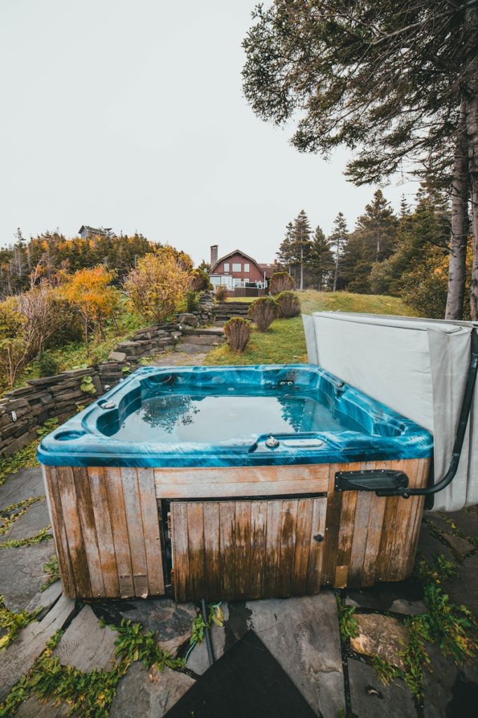a hot tub sitting on top of a stone walkway